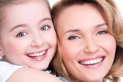 A lady and girl smiling