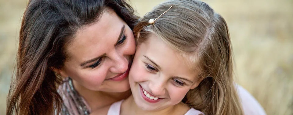 A lady and a girl smiling