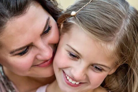 A lady and a girl smiling